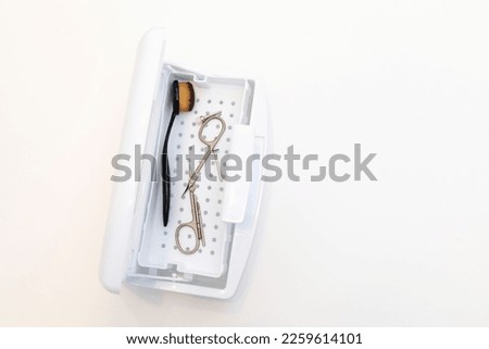 nail tool sterilizer box, plastic sterilization tray, closeup sanitizing machine. Safe manicure, pedicure in beauty salon. Hardware manicure nozzles, scissors, brush. Horizontal plane, copy space
