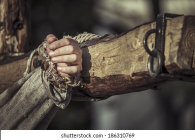 Nailed Hand On Wooden Cross. Crucifixion Of Jesus Christ.