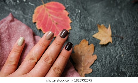 nails and autumn leaves. Place for text. Autumn beauty concept. 