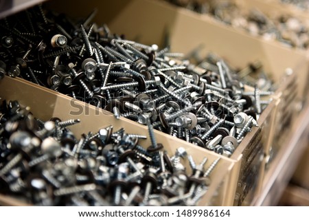 a lot of nails and screws in boxes. tools for repair. men's business. building. hobby . Selective focus