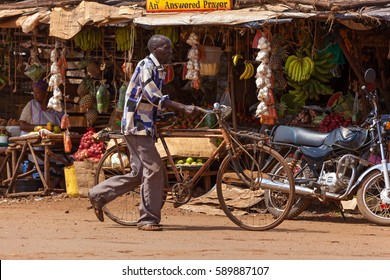 Nairobi, Kenya - 07 Januar 2013 A Man Rolls A Bicycle Down Street,people In Kenya