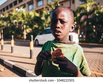 Nairobi / Kenya - 9/02/2018 : Young Boy Eating Muffin.