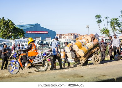 Nairobi, Kenya - December 9, 2016: Taxi Motorcycle And Barrels For Clean Water