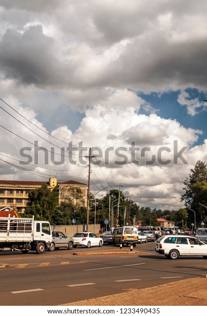 NAIROBI, KENYA - MAY 2014.Street scene in\
Nairobi. Cars and people in street. In background there are\
buildings, shops and advertising\
billboards.