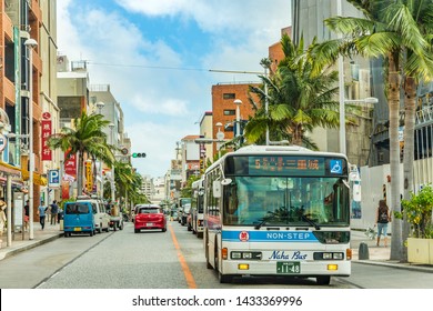 Nakagusuku, Japan - September 16 2018: Naha City Non-step Bus Running Through Palm Tree Lined Streets Under Okinawa Blue Summer Sky