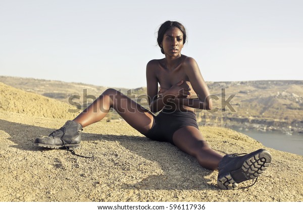 Black nude women seated Naked Black Woman Sitting Outdoors Stock Photo Edit Now 596117936