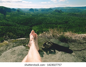 Naked Hairy Male Legs With Leather Sandals Rest While Trail. Person Enjoy Fantastic View Into Wild Landscape And Gains Again Power.