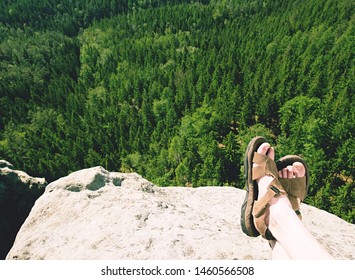 Naked Hairy Male Legs With Leather Sandals Rest While Trail. Person Enjoy Fantastic View Into Wild Landscape And Gains Again Power.