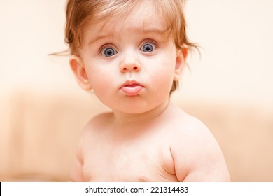 naked little kid staring at the camera
