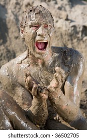 Naked Man Covered In Mud