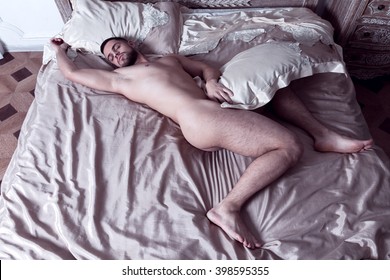 Naked man with great shaved butt is fast asleep in a bed