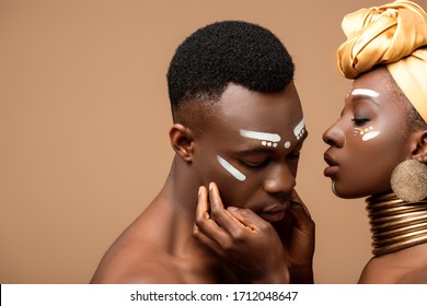 naked tribal afro couple posing isolated on beige