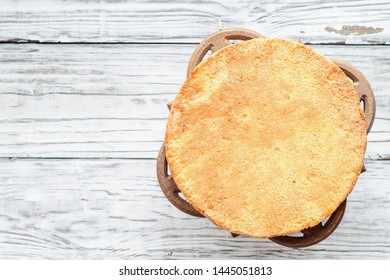 Naked Victoria Sponge Cake With Cake Stand Over A White Wooden Rustic Table Top. Image Shot For Above.