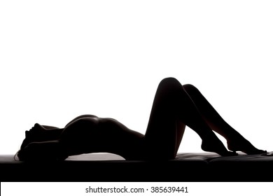 Naked Woman Lying On A Bed. Silhouette On A White