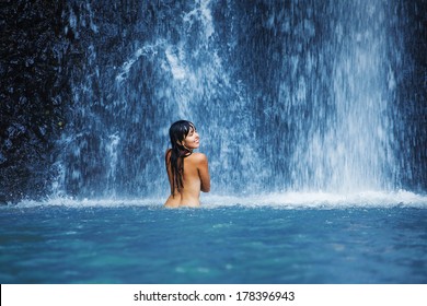 Naked Woman Washing In Waterfall