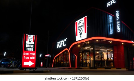 Nakhon Pathom, Thailand - February292020 : KFC Drive-through Fast Food Restaurant Is Opening To Serve Customers On Private Cars And Inside Of Store At Night