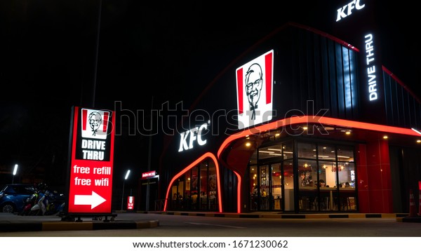 Nakhon Pathom, Thailand -\
February292020 : KFC Drive-through fast food restaurant is opening\
to serve customers on private cars and inside of store at\
night