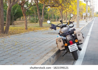Nakhon Pathom, Thailand - September 24, 2020 : Photo of Motorbike Royal Enfield of travelers taking a break on along the beautiful main road of Nakhon Pathom Province.