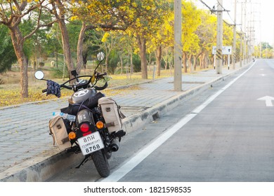Nakhon Pathom, Thailand - September 24, 2020 : Photo of Motorbike Royal Enfield of travelers taking a break on along the beautiful main road of Nakhon Pathom Province.