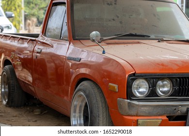 Nakhon Sawan, Thailand; February 18, 2020; Old Orange Pickup Truck Parts That Were Left Behind Until The Dust Caught.