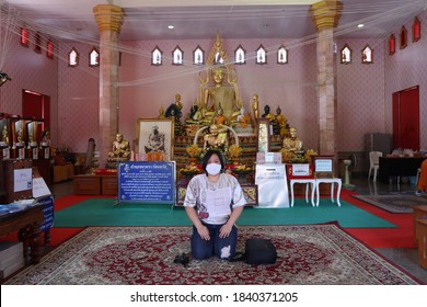 Nakhon Sawan, Thailand, October 23, 2020 Asian Women Travel In A Thai Temple Name Wat Woranat Banphot Ready To Put On A Mask For Cleanliness Prevention Of COVID 19