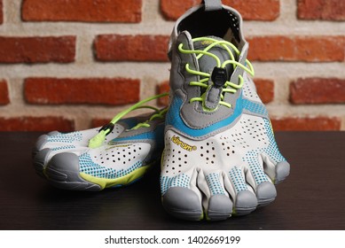 Nakhonpathom, Thailand - May 16, 2019 : Vibram V - Run. Natural Performance Running Shoe's With Grunge Wall Background. Running Shoe's For Barefoot Runner.