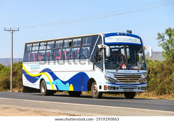 Nakuru County, Kenya - January 31, 2021:\
White intercity coach bus at the interurban\
road.