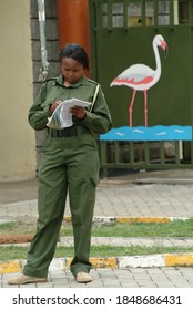 Nakuru, Kenya - August 18, 2010: Woman Park Ranger Takes Account Visitors Near Entrance In The Nakuru Lake National Park