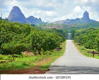 NAMAPA, MOZAMBIQUE - 6 DECEMBER 2008: Amazing, beautiful scenery. The road through the village. Strangers go on the way home in Namapa, Mozambique - 6 December 2008. The mountains in the background. 