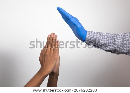 Namaste with bare hands and blessing wearing a surgical blue  gloves.
