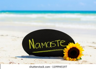 Namaste Sign On The Beach. Tulum, Mexico. Yoga Lifestyle. Sunflower On Tropical Beach. Mindfulness Living.