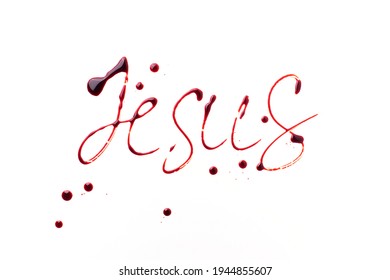 Name Jesus written with blood isolated on white background. Top view. Palm Sunday, Good Friday, Easter concept, Christ resurrection. Christianity symbol and faith