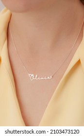 Name Silver Necklace On Attractive Female Model. Woman Wearing Personalized Necklace. Jewelry Photo For E Commerce, Online Sale, Social Media.