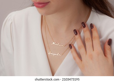 Name silver necklace on attractive female model. Woman wearing personalized necklace. Jewelry photo for e commerce, online sale, social media.