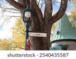 A name of a street  in Quebec city with a beautiful street light.  A street sign near of the Plains Abraham in Quebec city and with the name Tache. The way to go in the park of Battlefield in Canada.