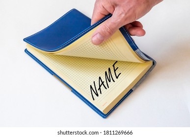 NAME word on paper of notebook opened by male hand, brand and naming concept - Powered by Shutterstock