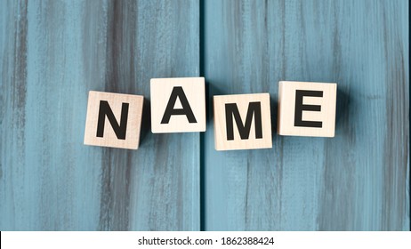 NAME word written on wood block. NAME text on wooden table for your desing, concept.
