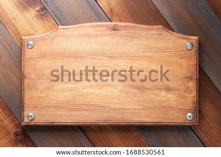 nameplate or wall sign at  wooden background texture surface with screws