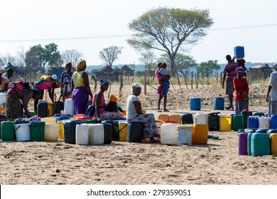 NAMIBIA, KAVANGO, OCTOBER 15: Unidentified Namibian woman with child near public tank with drinking water.Kavango region. October 15, 2014, Namibia
