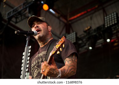 NAMPA, IDAHO - SEPTEMBER 25 :Aaron Lewis plays his guitar druing the performance of Staind Rockstar Uproar Festival on September 25, 2012 in Nampa, Idaho.