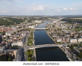 NAMUR, BELGIUM - SEPTEMBER 21, 2021: Aerial footage of Namur city showing architecture, buildings, parcs, bridges and the Citadelle, a fortress at the confluence of the Sambre and Meuse rivers