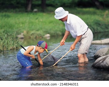 Namwon-si, Jeollabuk-do, South Korea - July 1, 2002: Summer View Of Boy And Grandfather Fishing On The Brook
