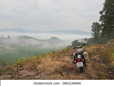 Nan, Thailand - December 8, 2018 : Photo of Motorbike Royal Enfield of traveler taking a break to see the beautiful nature during the journey at Nan Province.