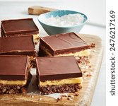 Nanaimo bars - traditional Canadian dessert with wafer crumbs, almond, walnut and cocoa layer, vanilla custard filling and chocolate topping, nanaimo bar scone