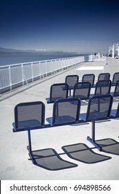 NANAIMO, BC, CANADA - MAY 27, 2017: Outdoor seats and Western view of clear blue sky and Strait of Georgia from top deck of a BC Ferries ferry ship en route from Tsawwassen to Nanaimo, BC, Canada.
