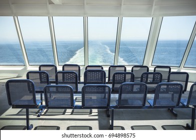 NANAIMO, BC, CANADA - MAY 27, 2017: Outdoor seats and Western view of clear blue sky and Strait of Georgia from top deck of a BC Ferries ferry ship en route from Tsawwassen to Nanaimo, BC, Canada.