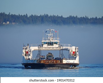 Nanaimo, Canada - January 15, 2021: A BC Ferries passenger and car ferry arrives in Nanaimo on Vancouver Island from nearby Gabriola Island on a sunny, but foggy day.