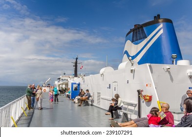 Nanaimo, Canada - June 29, 2014: Passengers on the sun deck of the BCF Ferry Queen of Oak Bay. BC Ferries provides all major passenger and vehicle ferry services in British Columbia.