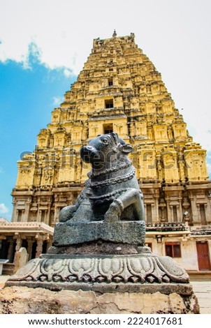 Nandi statue with main gopuram or gopura at Virupaksha temple hampi karnataka india. unesco world heritage site