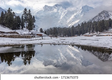 Nanga parbat mountain reflection in lake on Fairy meadows valley beautiful winter snowy landscape Karakoram Pakistan